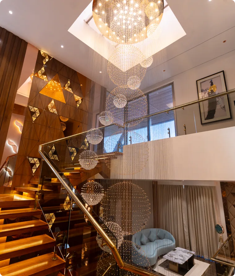 Staircase beneath a sculptural chandelier
